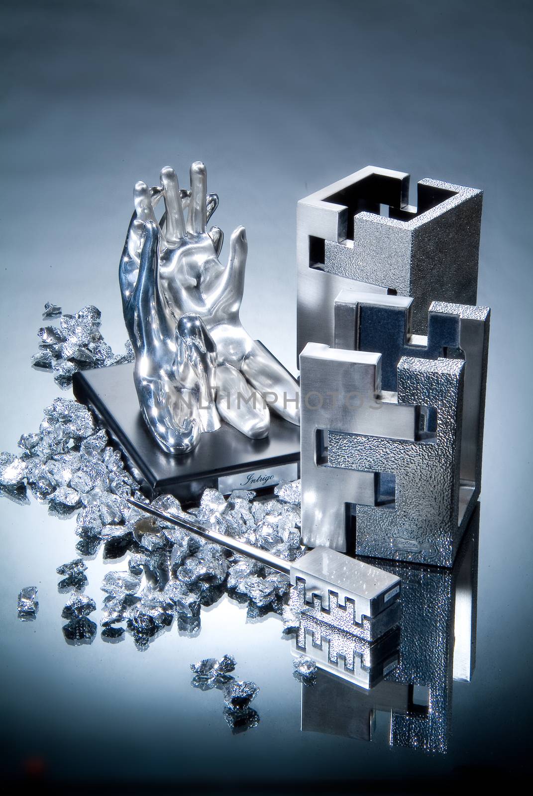 Metal statuettes on a glass studio background
