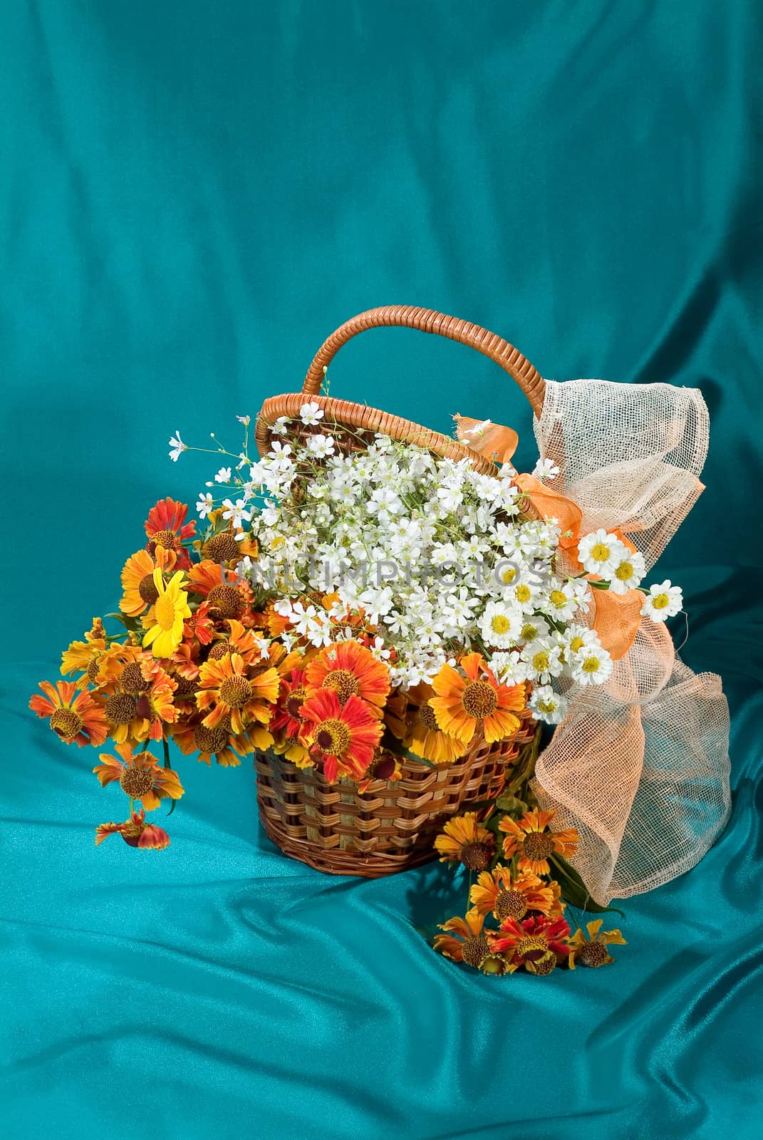 Still life with bouquet of flowers and accessories on a studio background