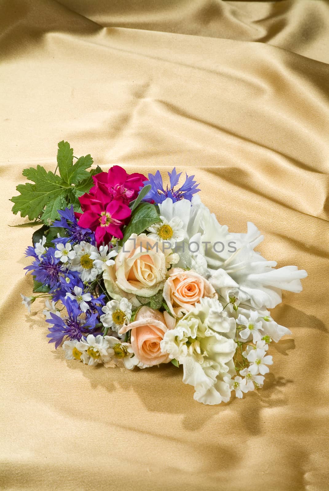 Still life with bouquet of flowers and accessories on a studio background