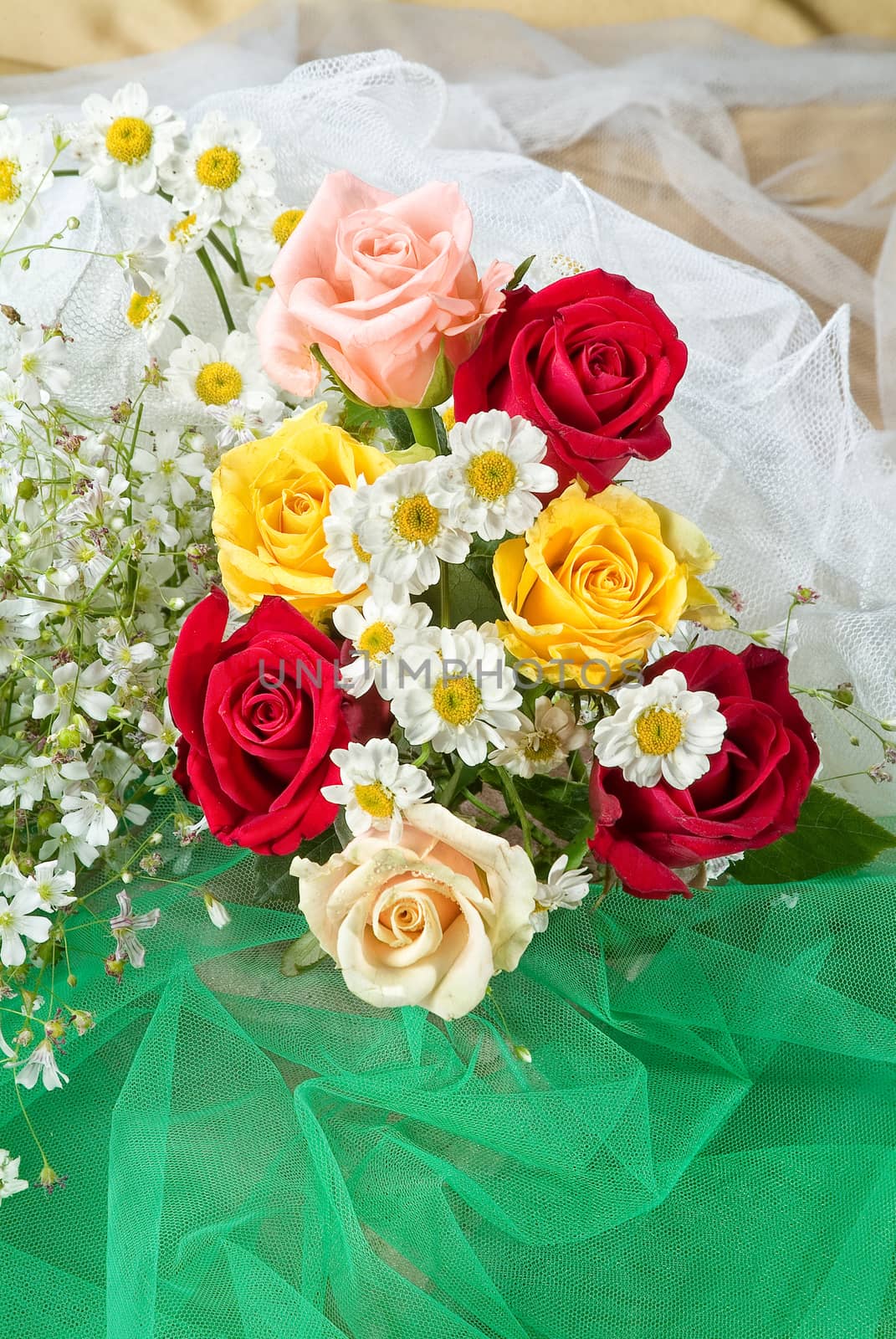 Still life with bouquet of flowers and accessories on a studio background