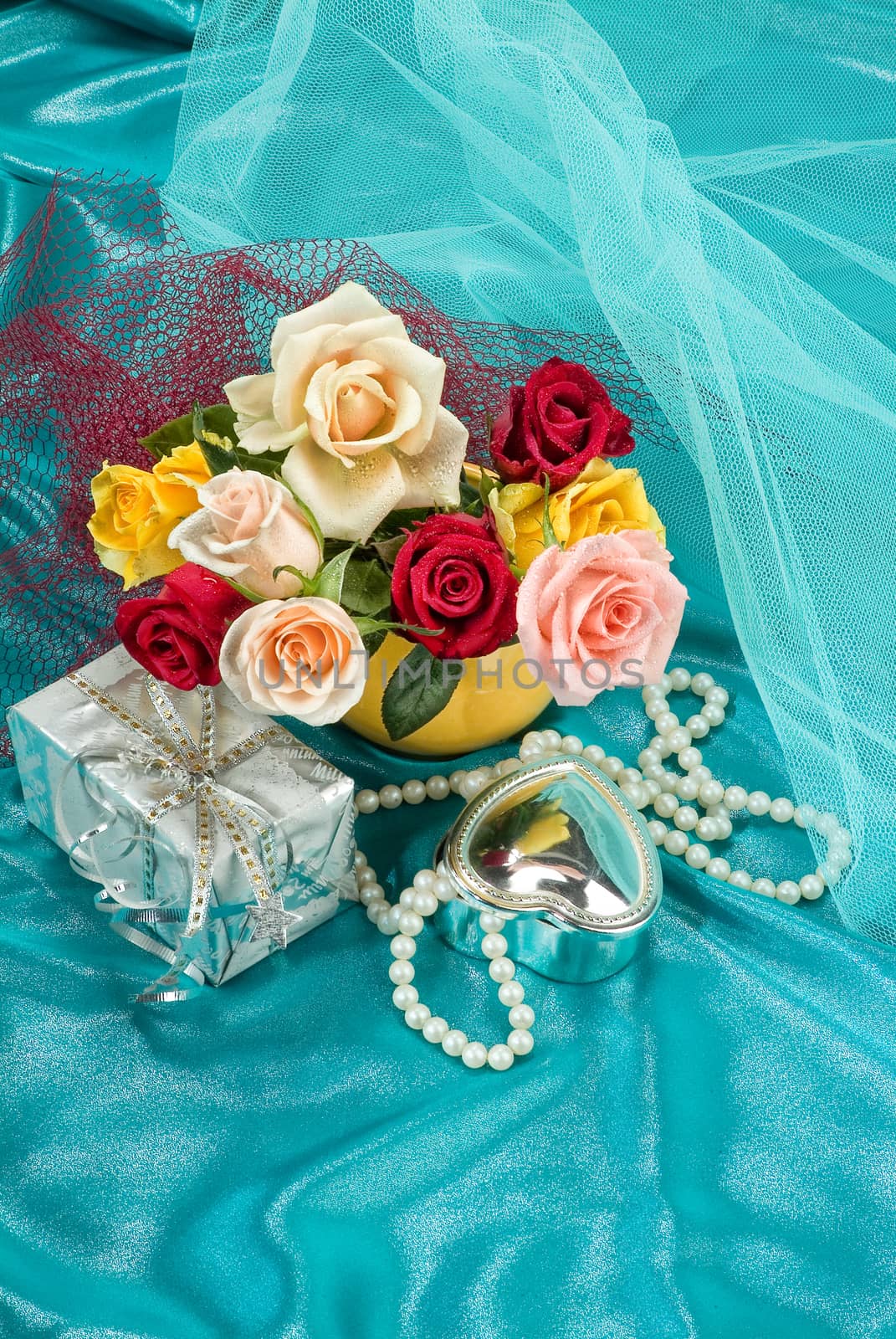 Still life with bouquet of flowers and accessories on a studio background