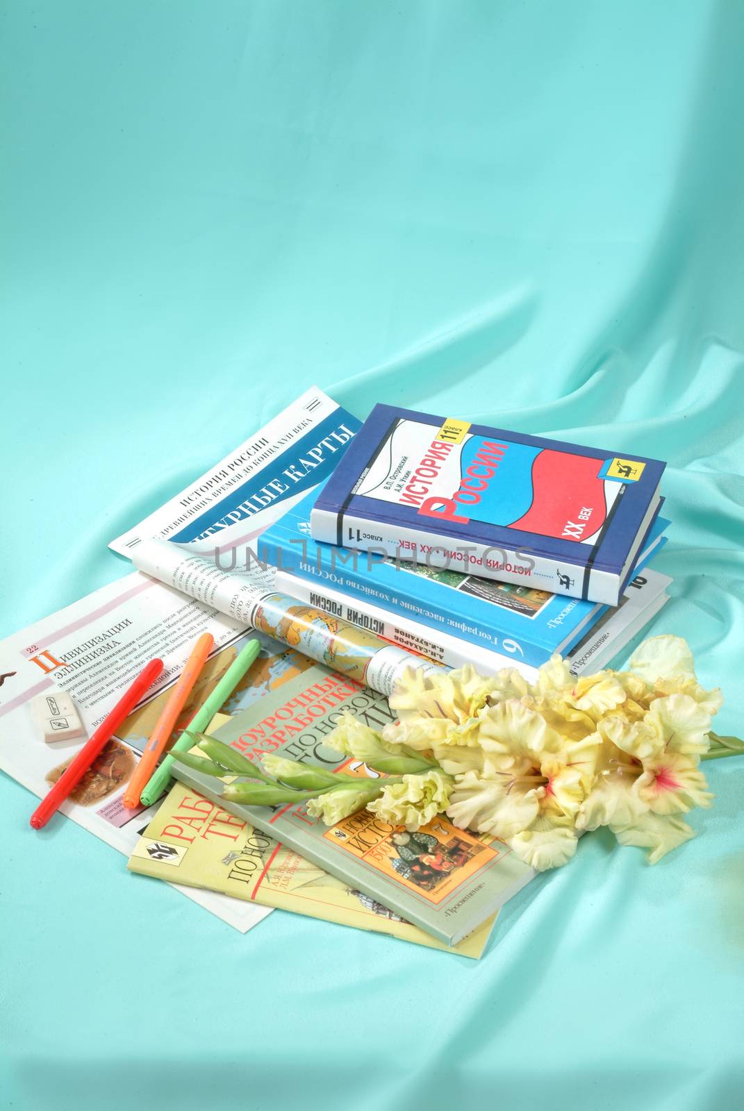 School books and accessories on a studio background