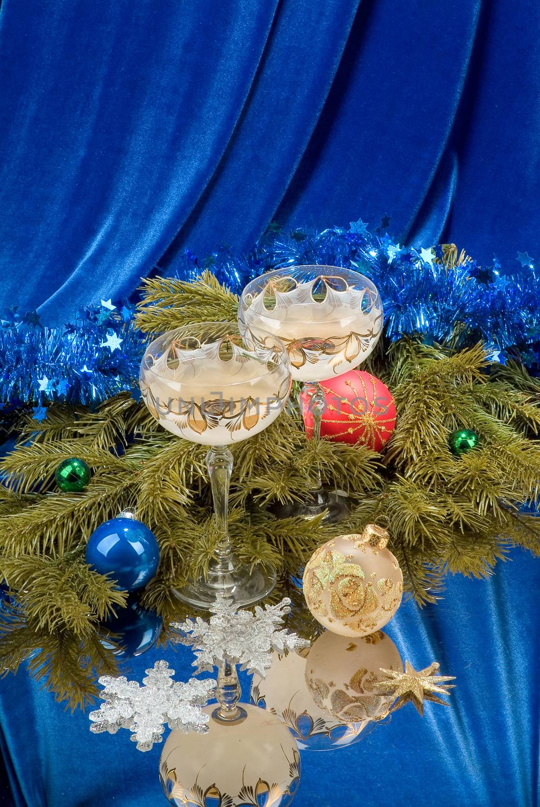 Glasses, New Year tree and balls on a studio background