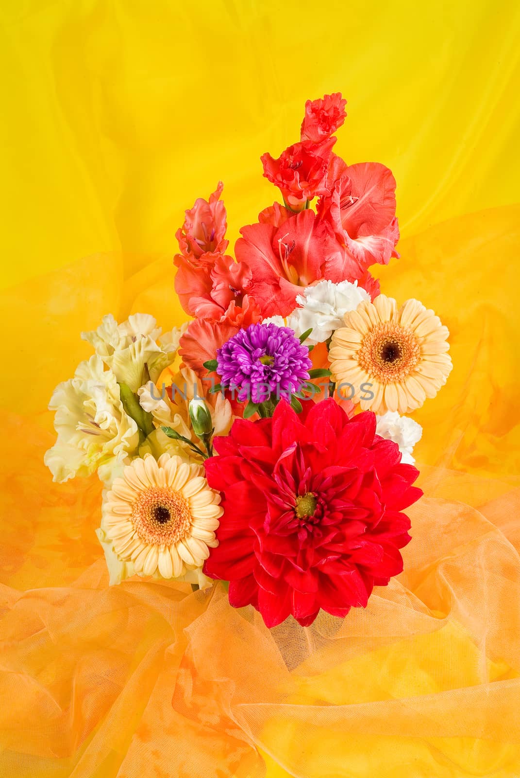 Still life with bouquet of flowers and accessories on a studio background