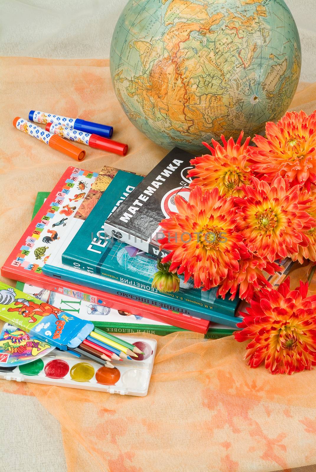 School books and accessories on a studio background