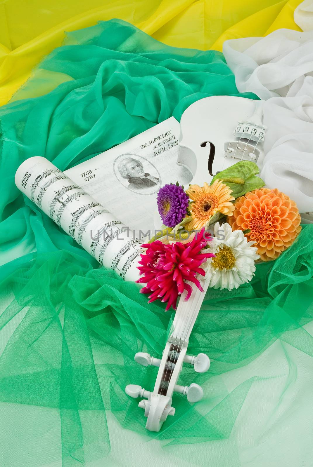 Still life with bouquet of flowers and accessories on a studio background