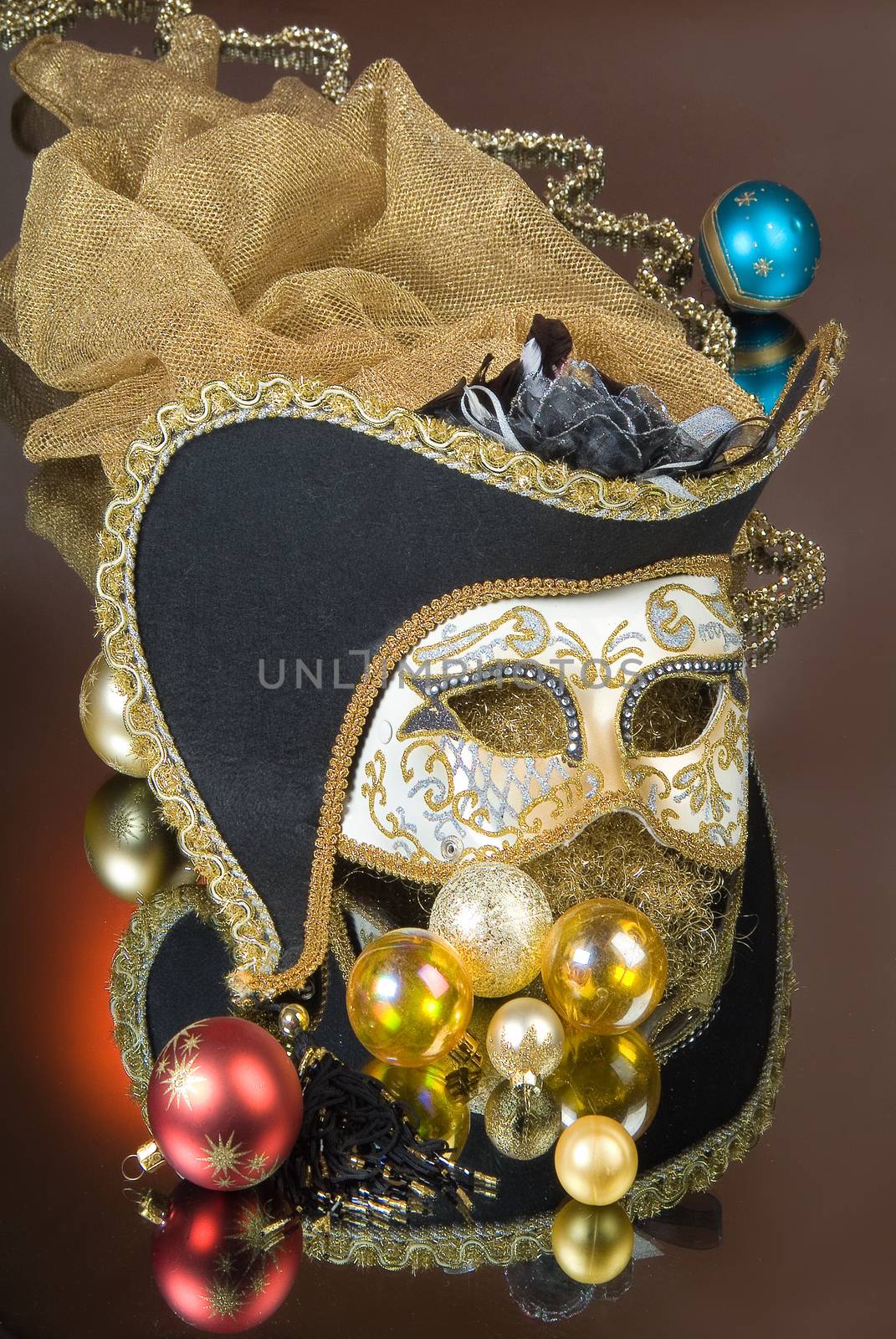 Mask and New Year balls on a glass studio background