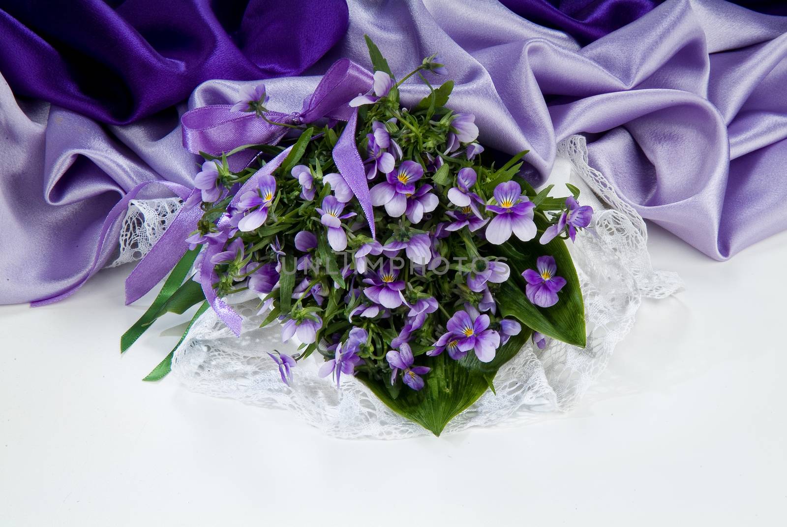 Still life with bouquet of flowers and accessories on a studio background