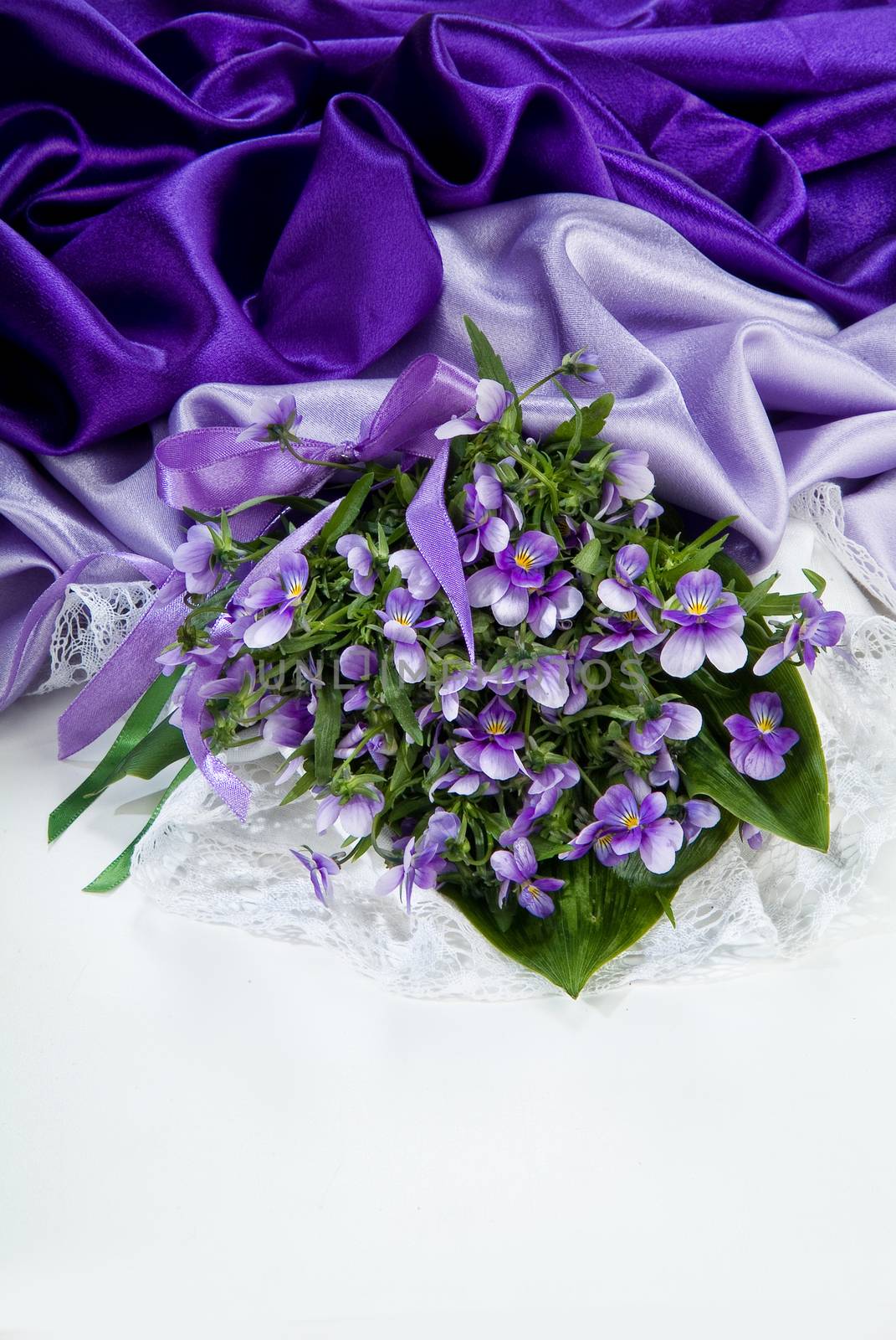 Still life with bouquet of flowers and accessories on a studio background