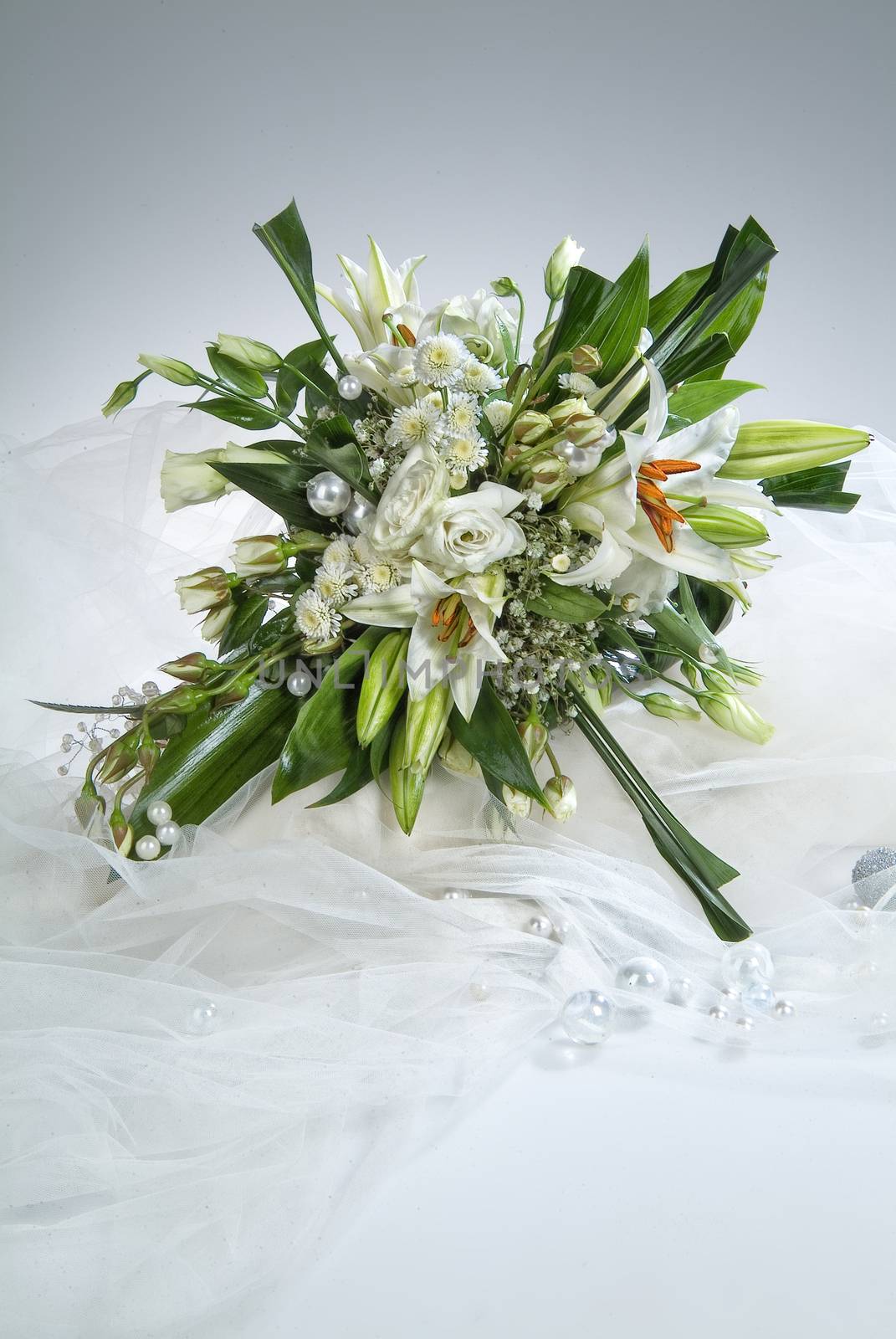 Still life with bouquet of flowers and accessories on a studio background