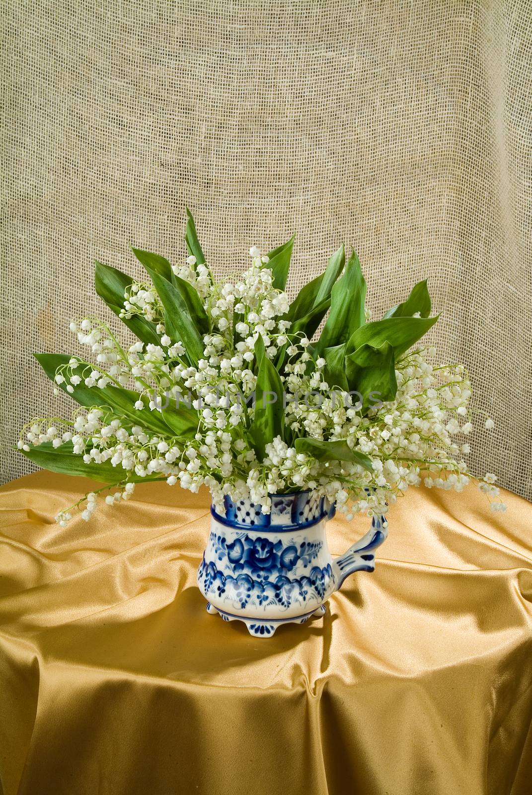 Still life with bouquet of flowers and accessories on a studio background