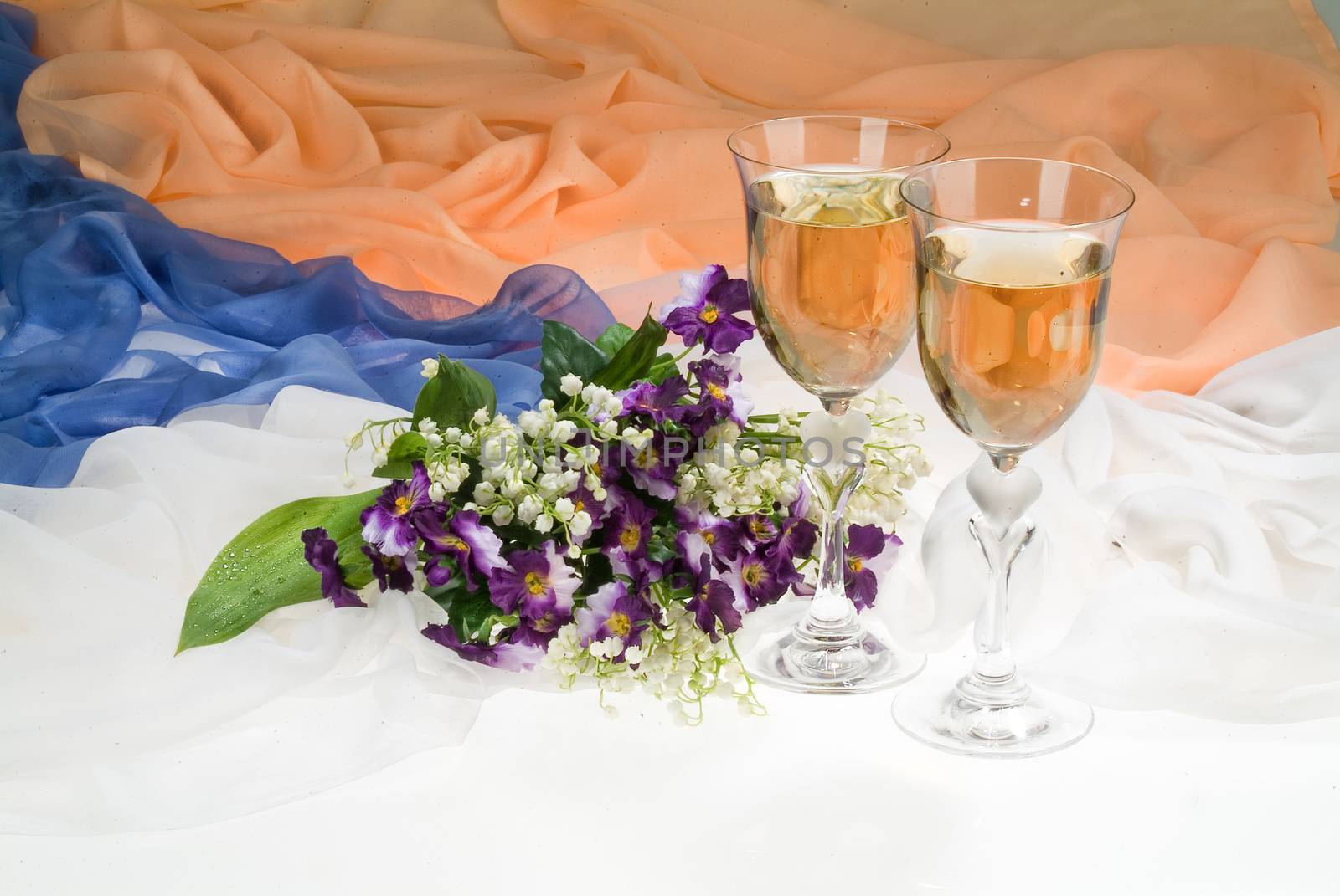 Still life with bouquet of flowers and accessories on a studio background