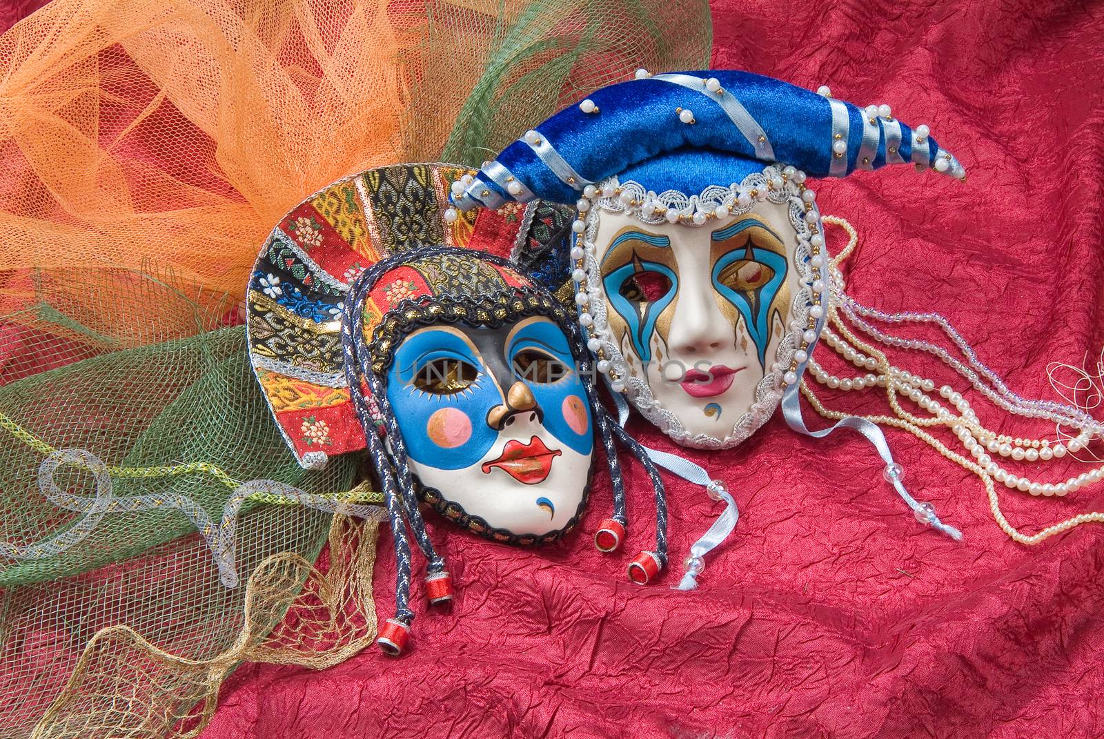 Venetian carnival masks on a fabric studio background