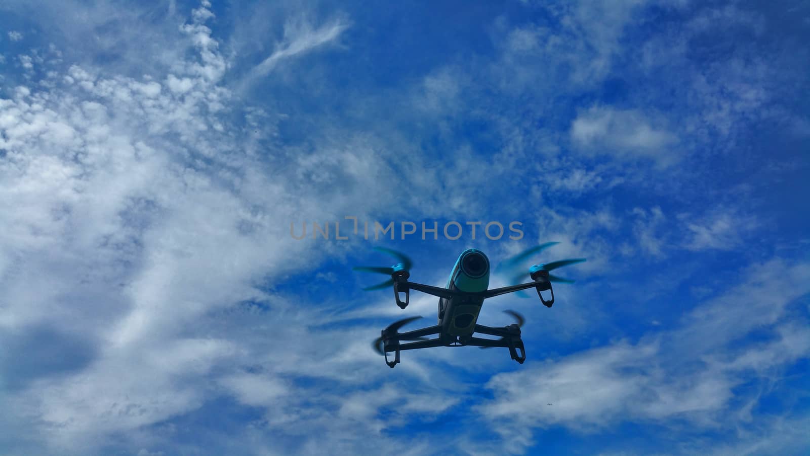 blue drone on the blue sky with white clouds