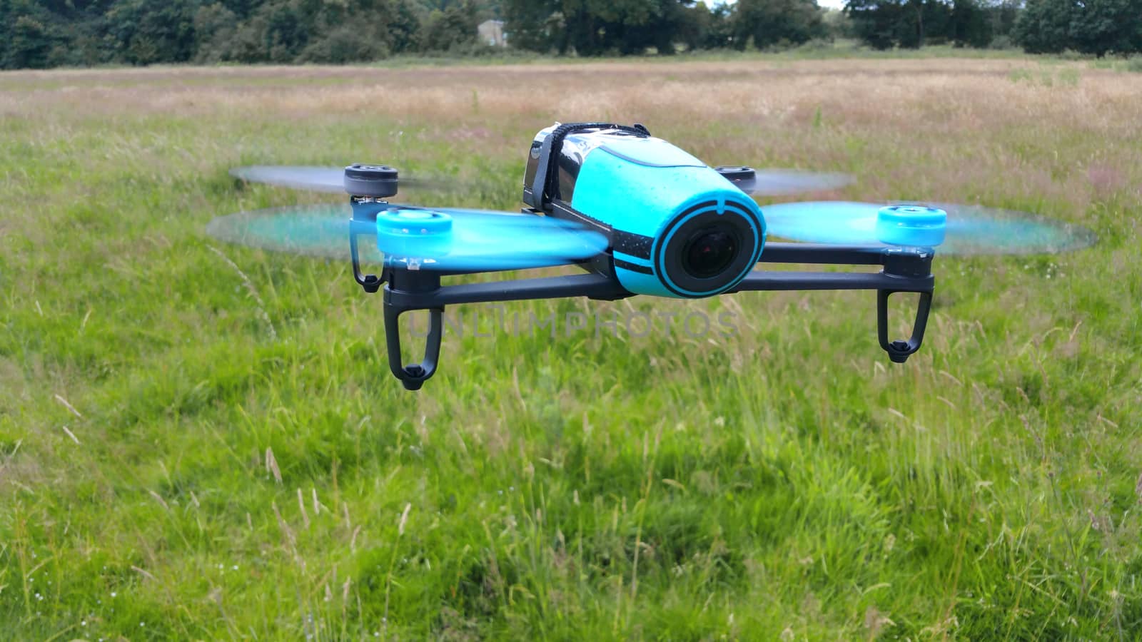blue drone on the green grass background