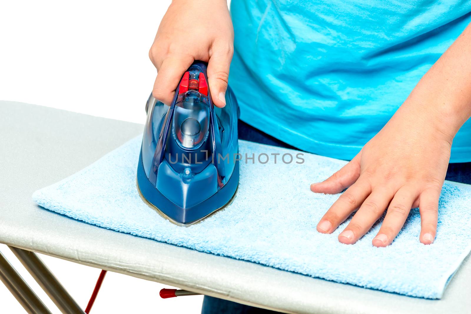 closeup of male hands with iron while ironing terry towel