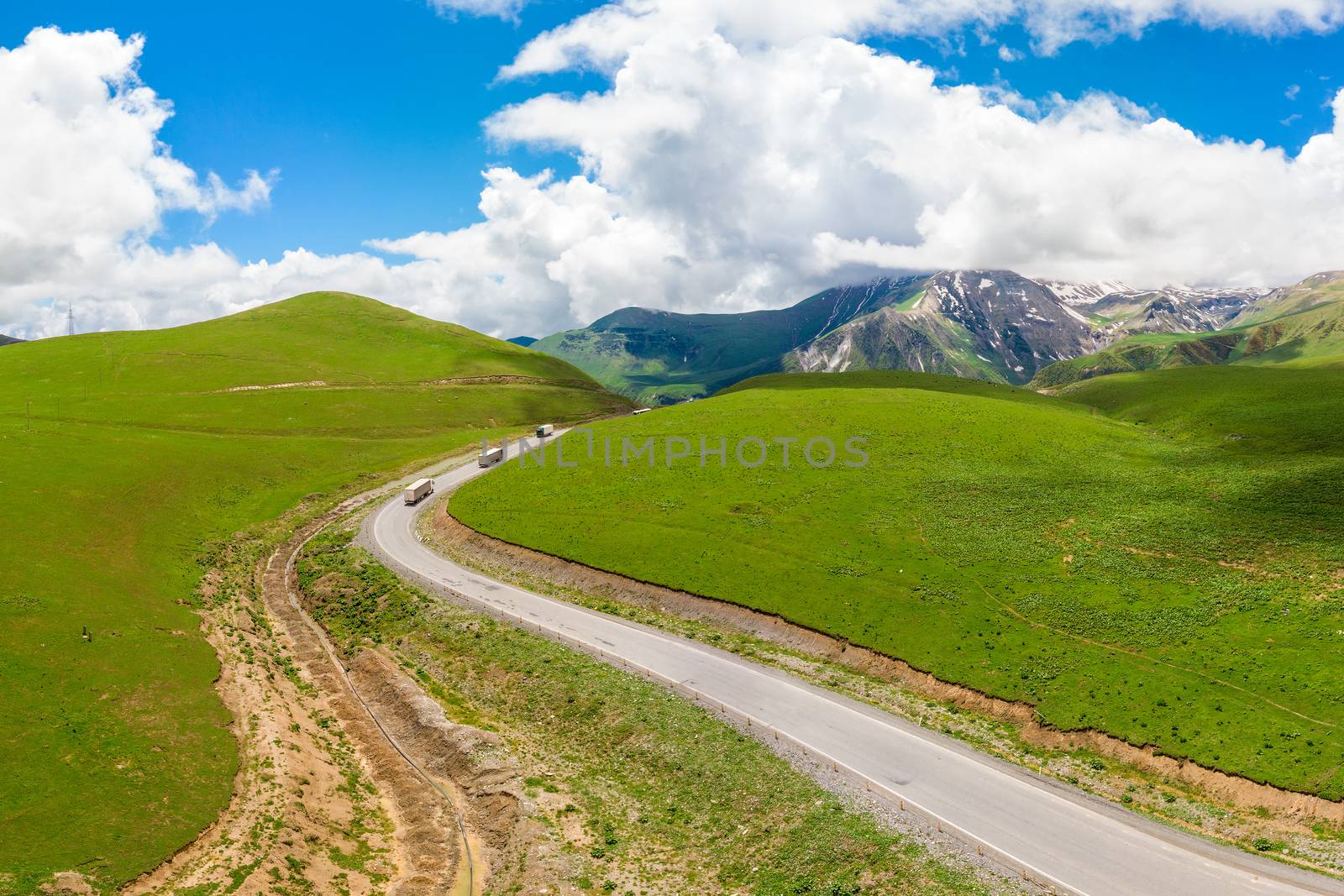Wagons on a mountain road, scenic landscape from quadrocopter top view