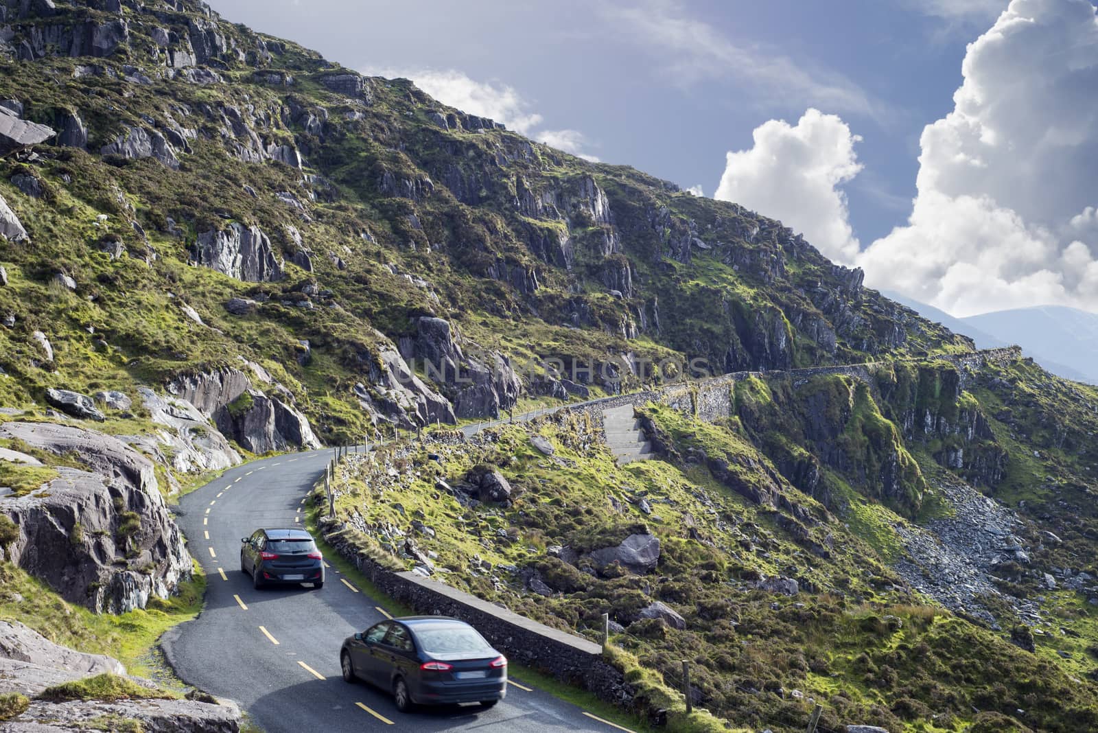 mountains and cliff road traffic at the conor pas by morrbyte