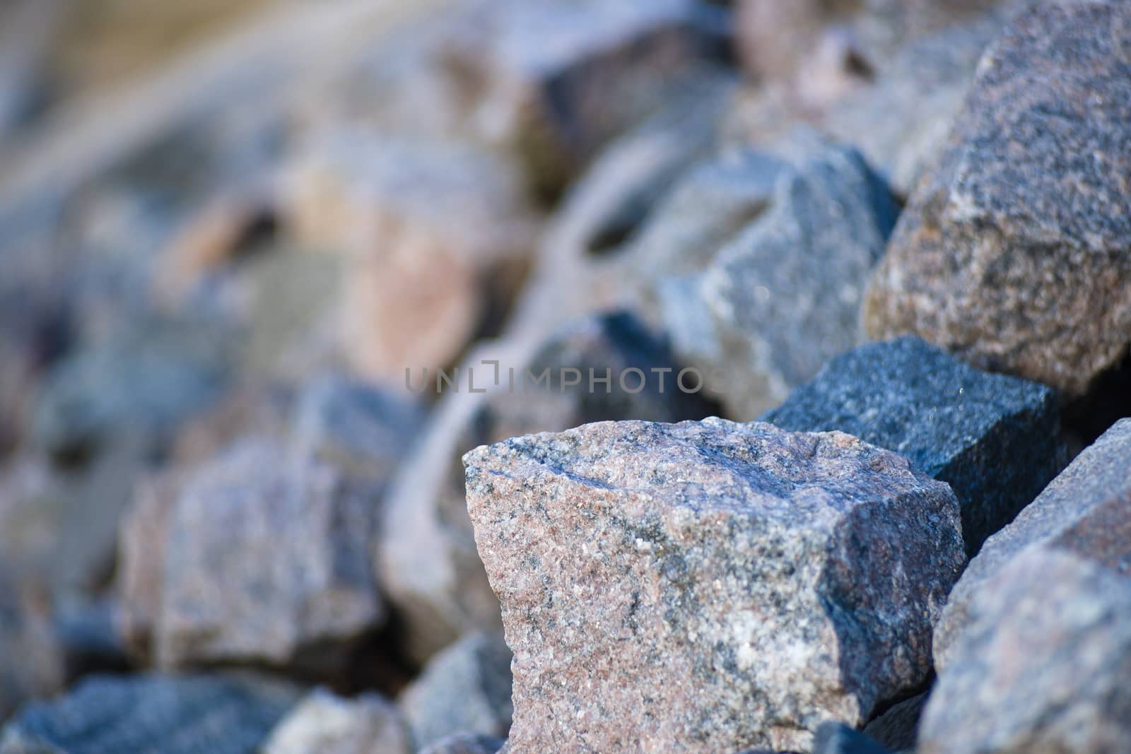 heap of stones on the river bank. heaped stones by alexsdriver