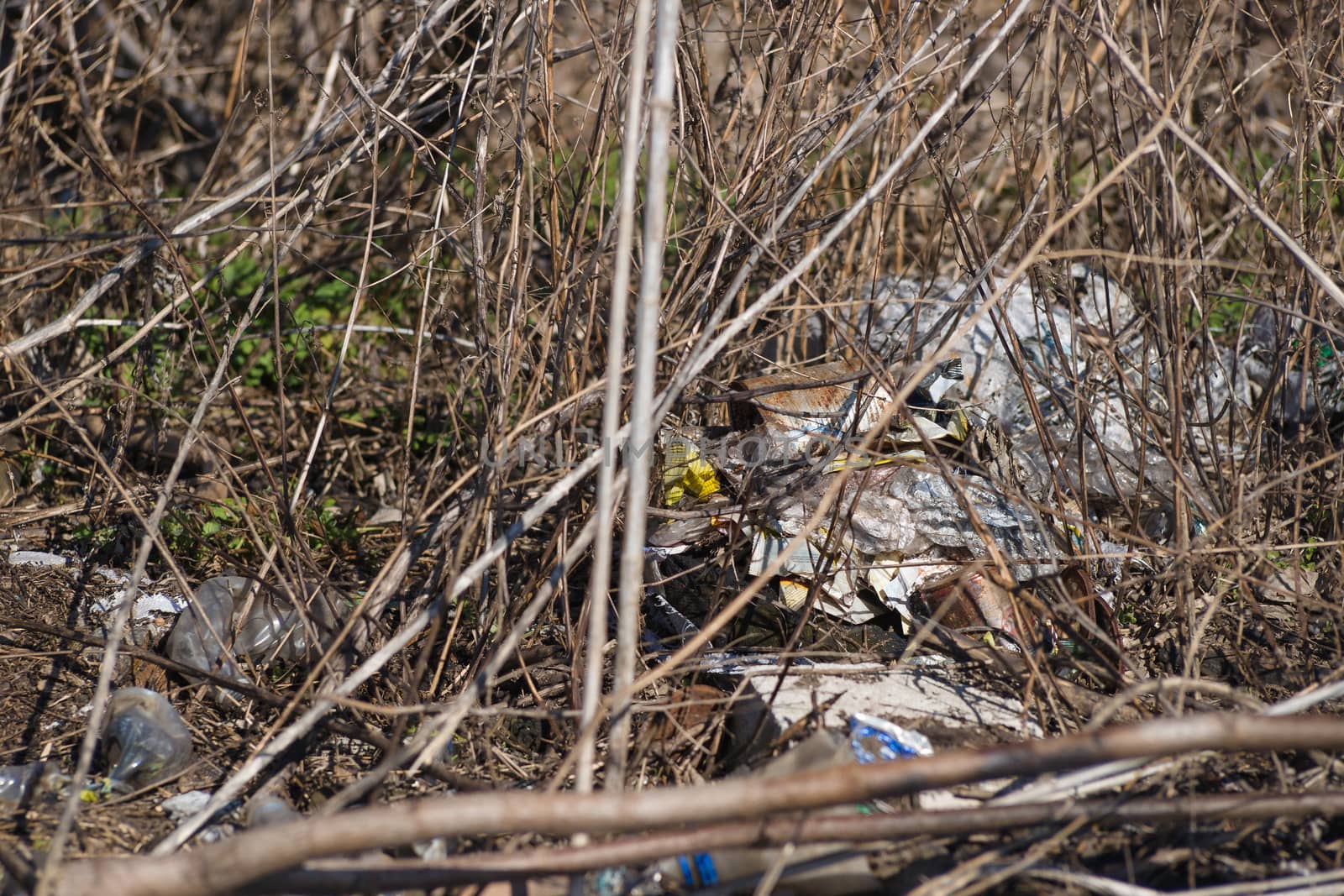 Trash on the agriculture field. Ecology problem and big harm to  by alexsdriver