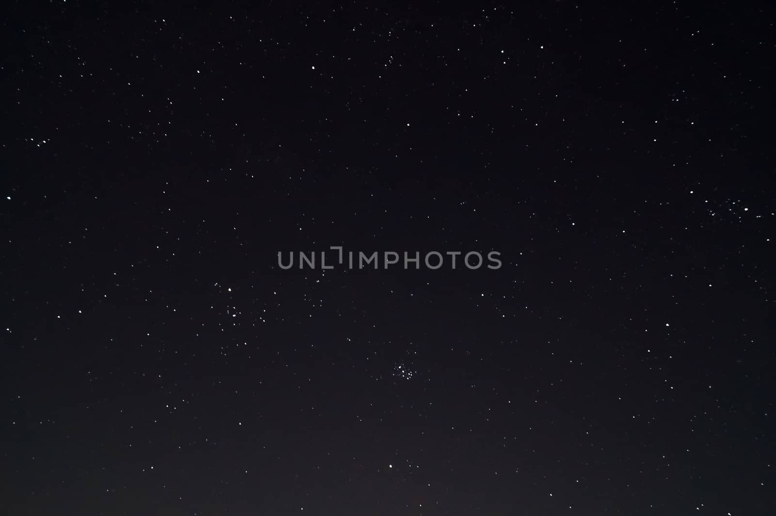 Underexposed night sky low light photo. A lot of stars and constellations on dark sky. Stock photo of deep sky.