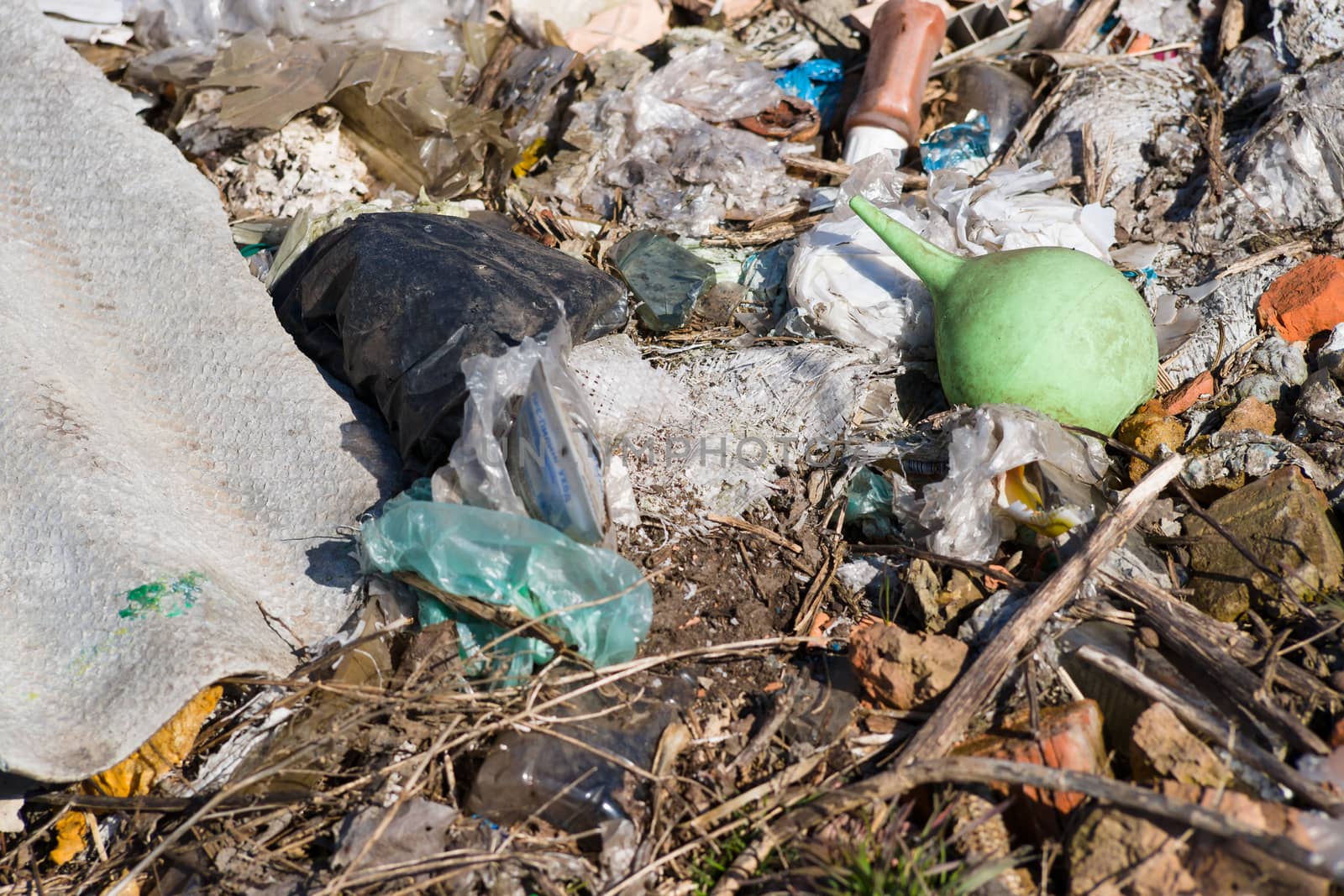 Trash on the agriculture field. Ecology problem and big harm to  by alexsdriver