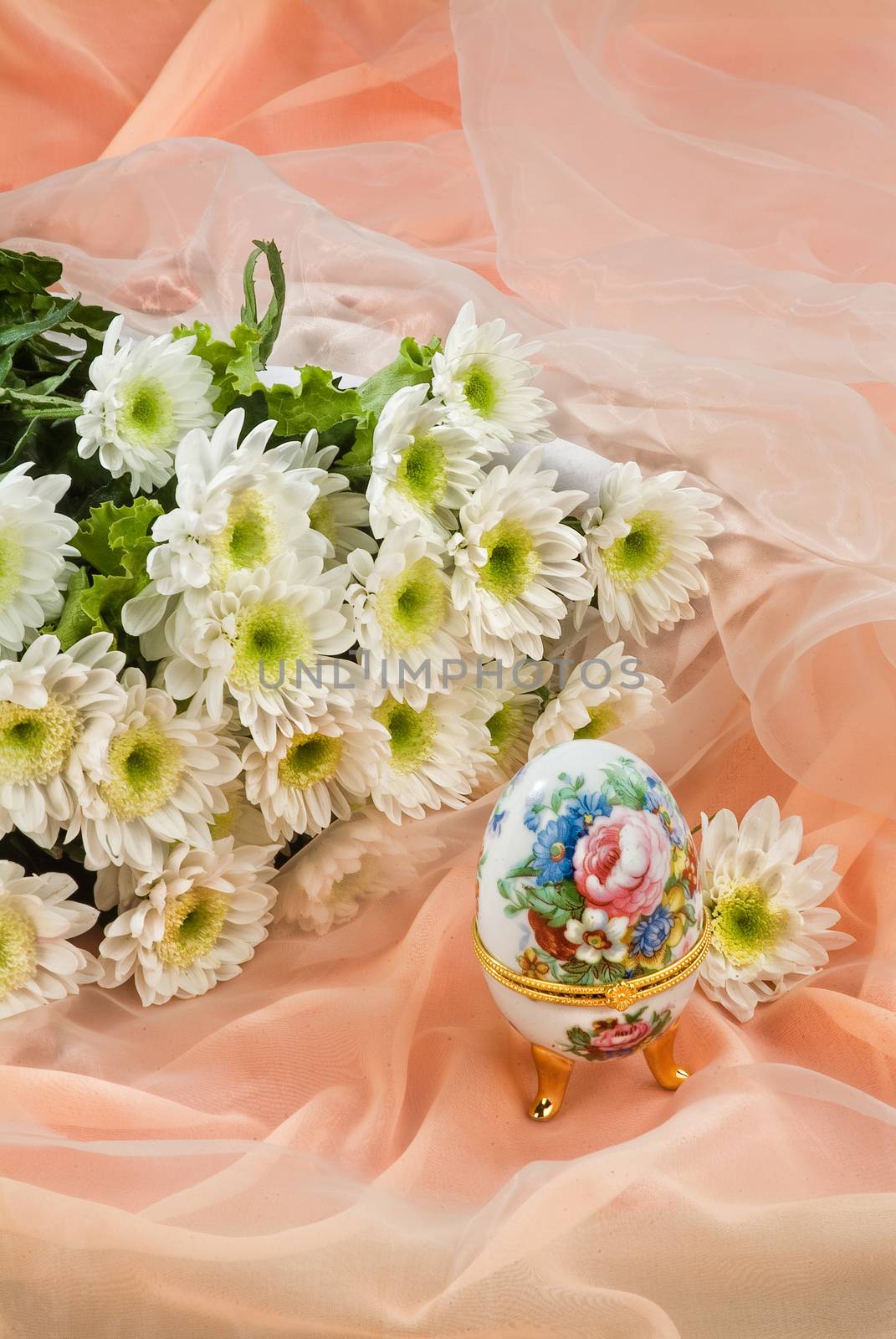Still life with bouquet of flowers and accessories on a studio background