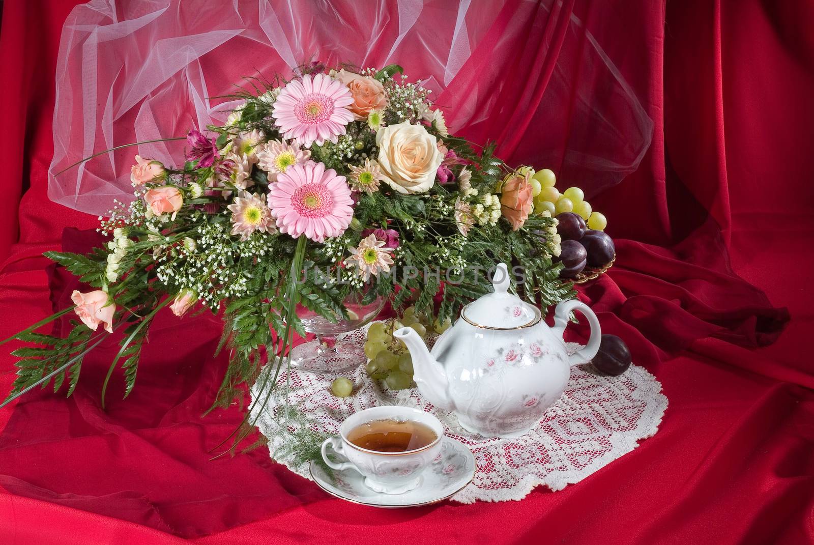 Still life with bouquet of flowers and accessories on a studio background