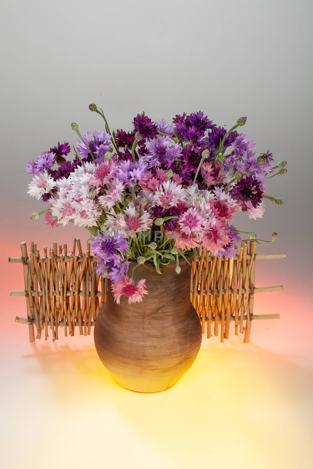 Still life with bouquet of flowers and accessories on a studio background