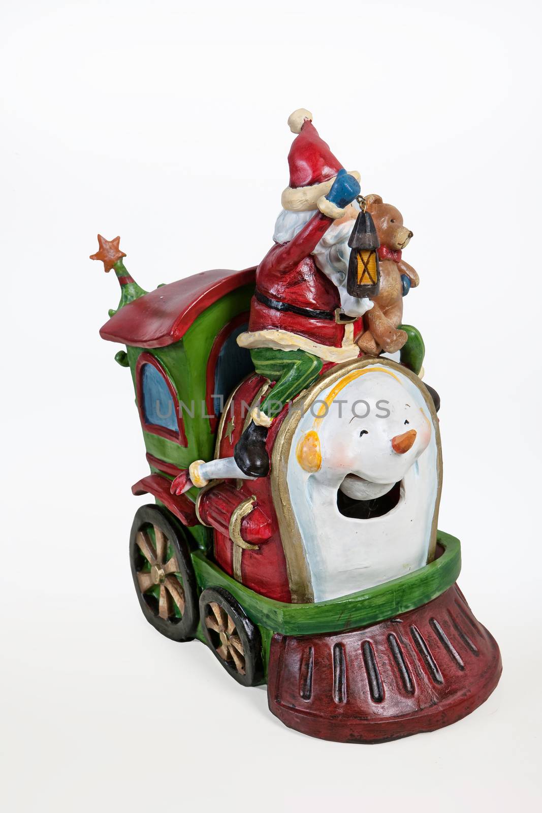 Statuette of Santa Klaus on old fashioned locomotive on isolated background