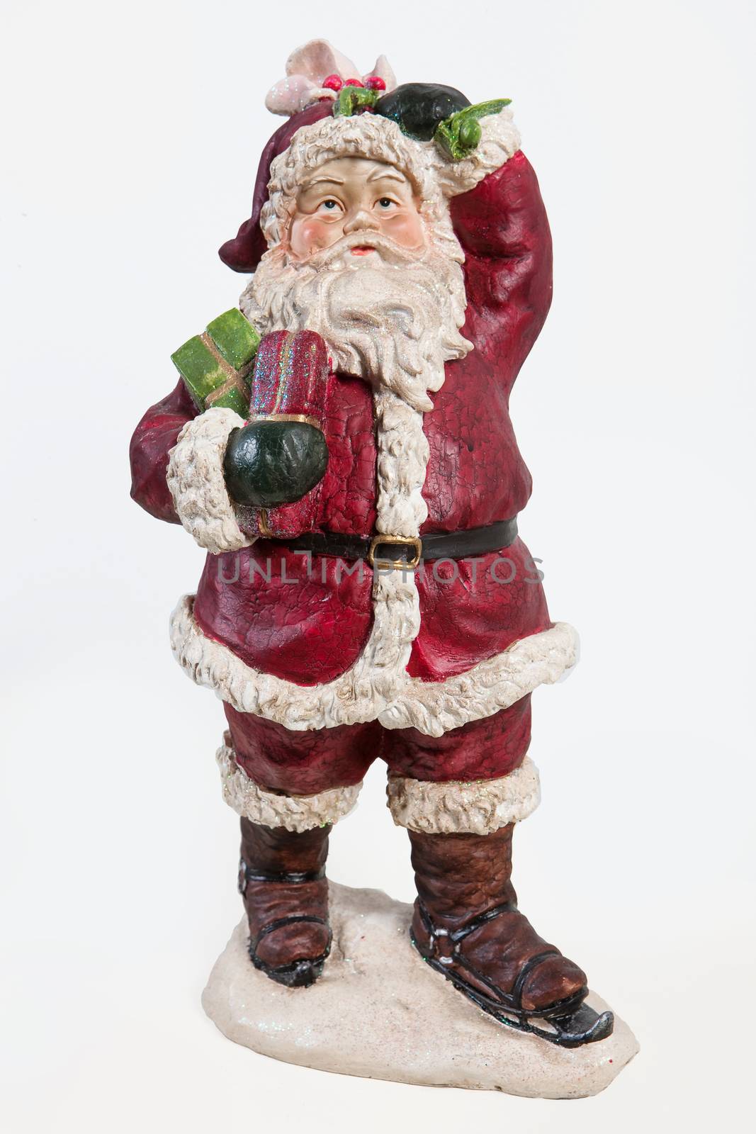 Old fashioned handmade statuette of Santa Klaus on isolated background