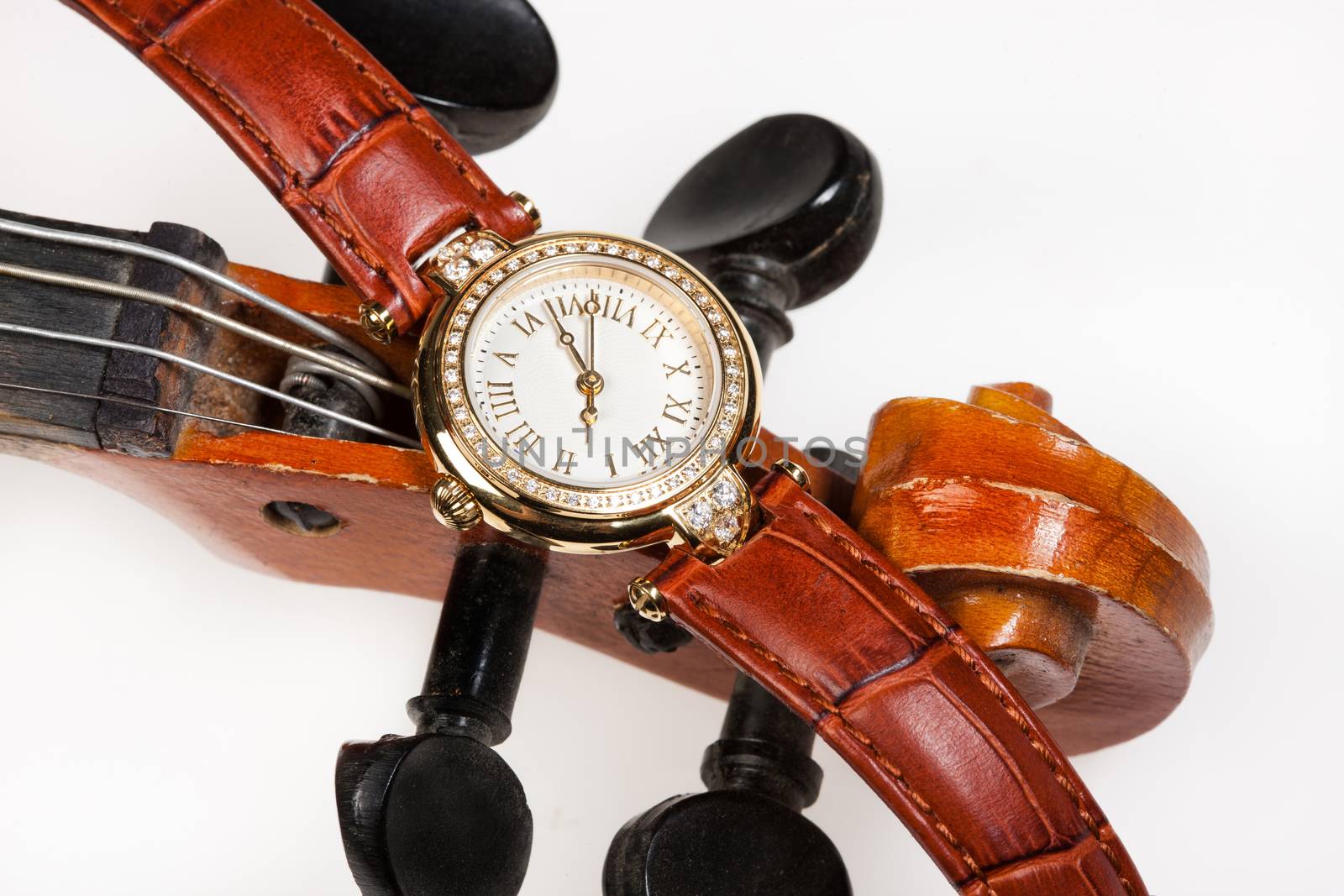 Watch with jewels and part of violin on isolated background