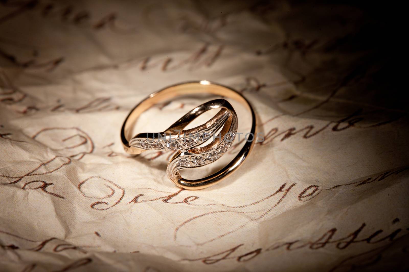 Golden ring with gem on an old manuscript