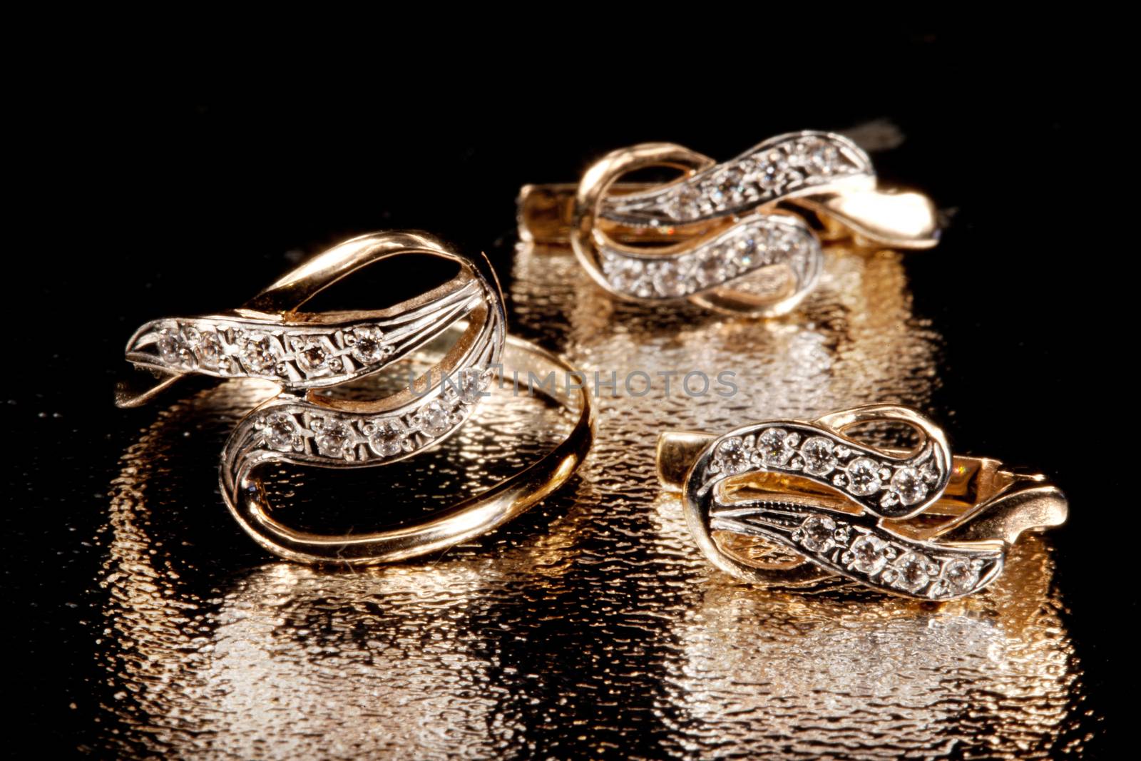 Golden rings on a glitter studio background