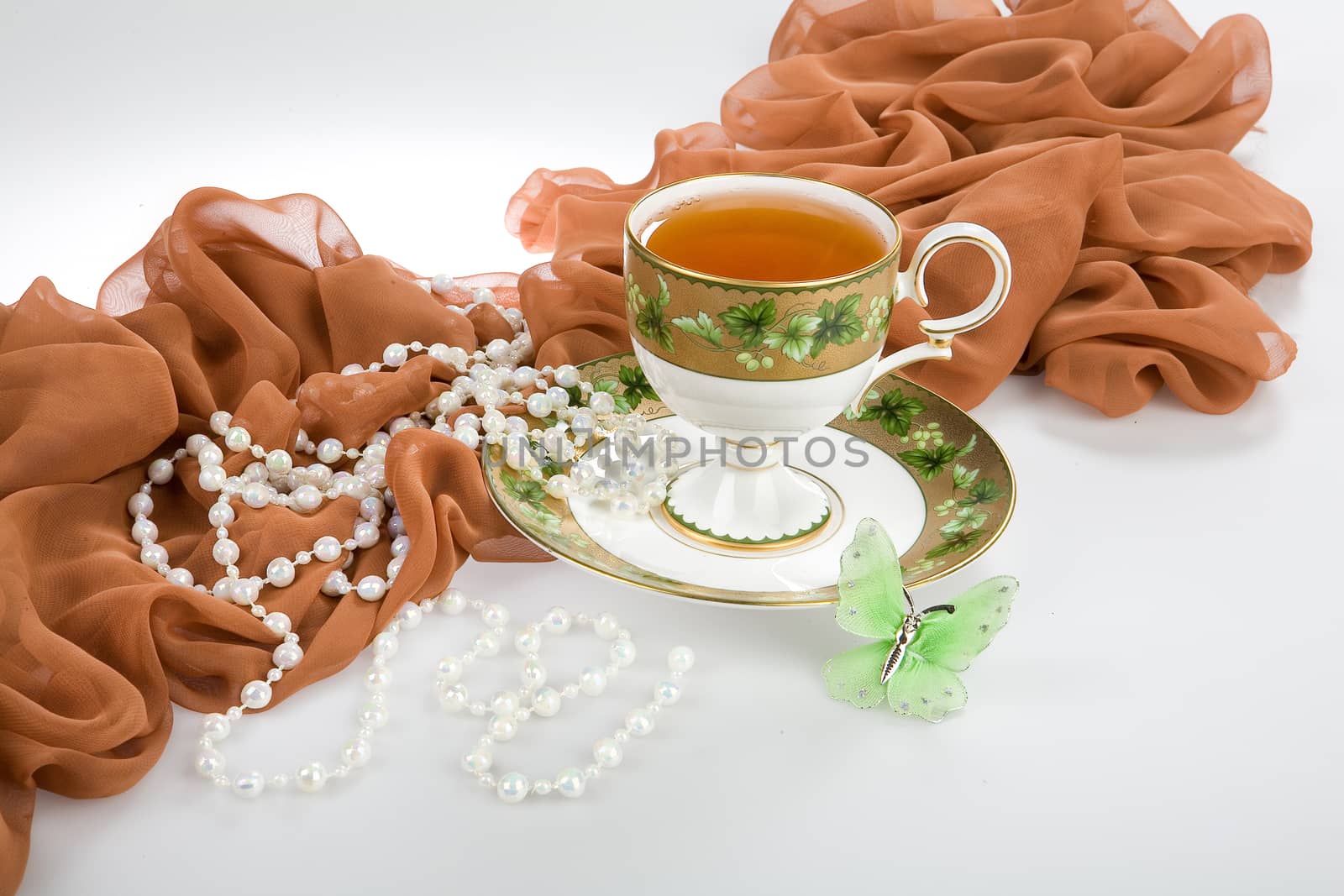 Still life with bouquet of flowers and accessories on a studio background