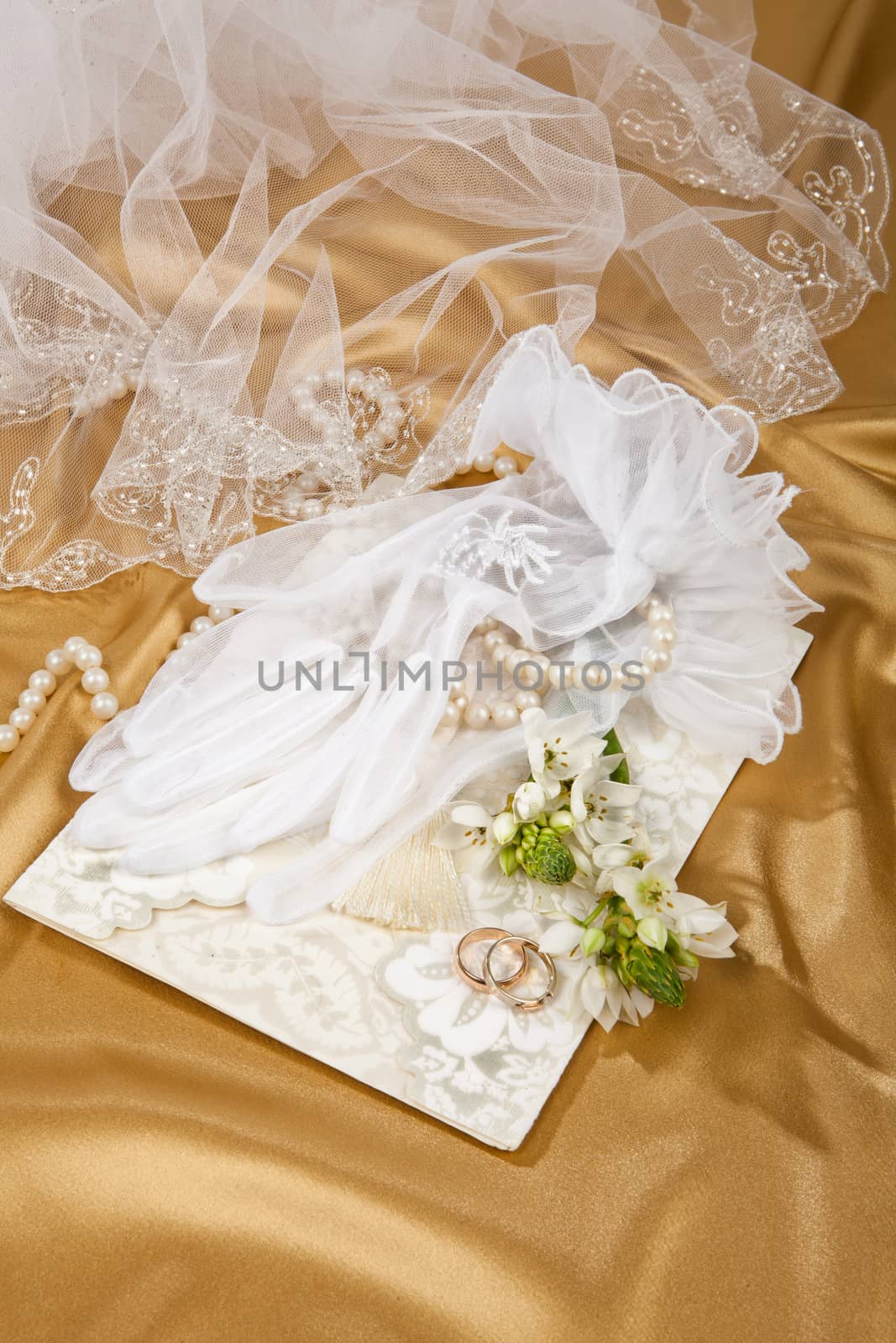 Still life with bouquet of flowers and accessories on a studio background