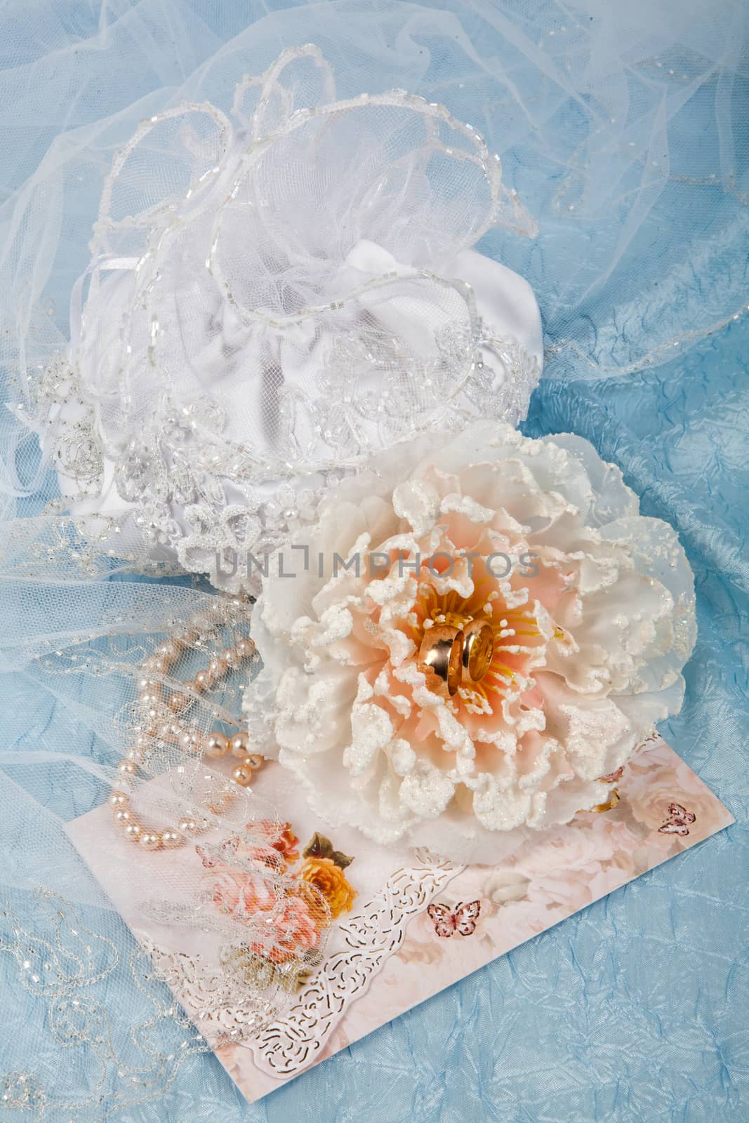 Still life with bouquet of flowers and accessories on a studio background