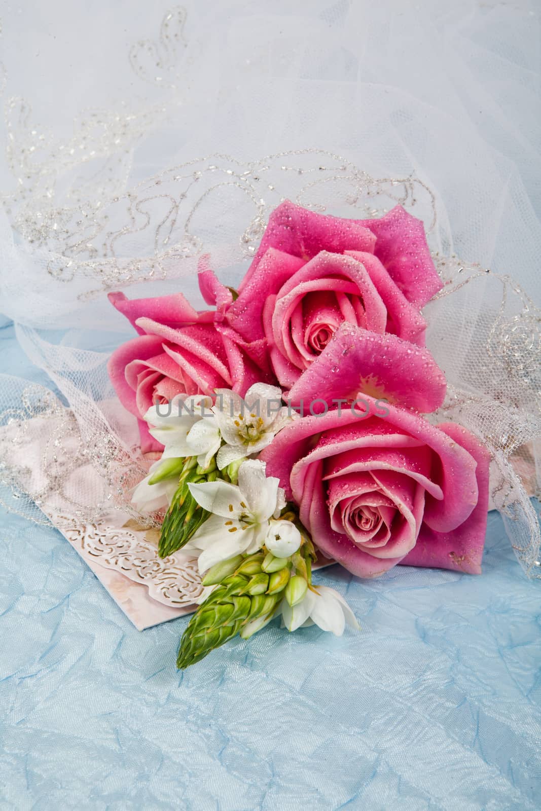 Still life with bouquet of flowers and accessories on a studio background