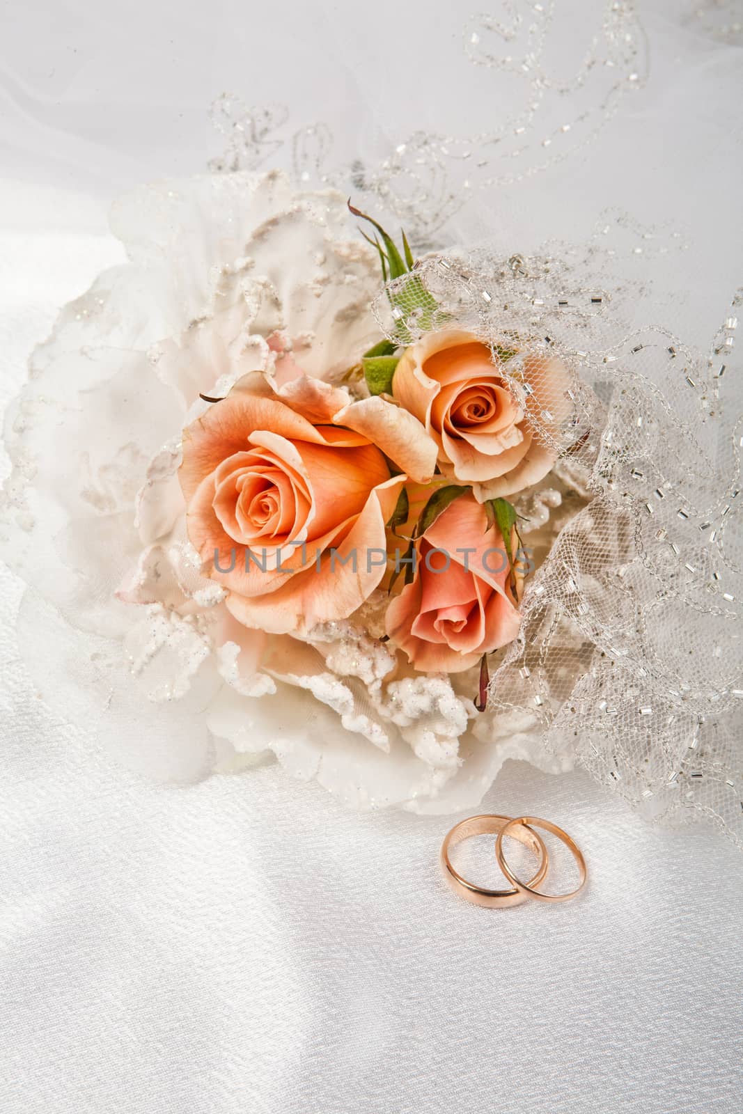 Still life with bouquet of flowers and accessories on a studio background