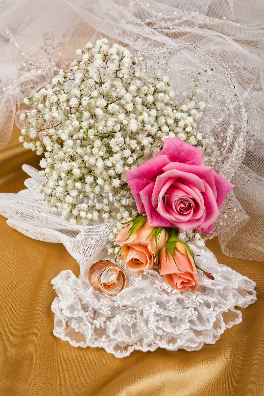 Still life with bouquet of flowers and accessories on a studio background