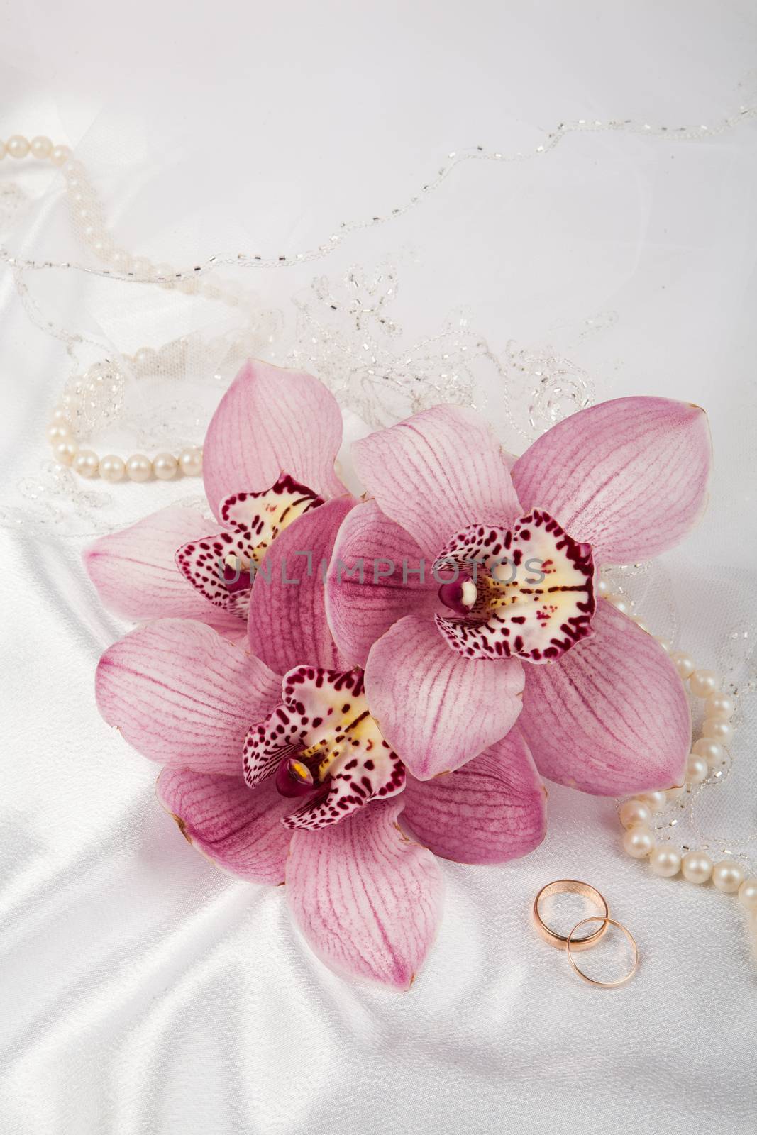 Still life with bouquet of flowers and accessories on a studio background