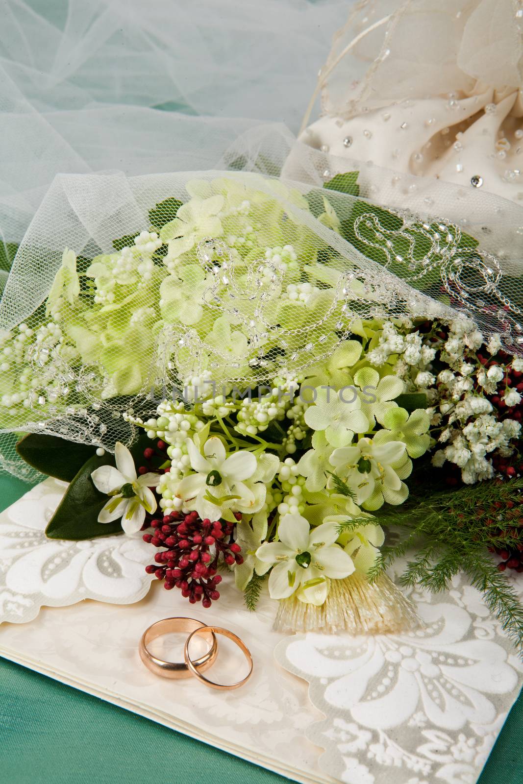 Still life with bouquet of flowers and accessories on a studio background