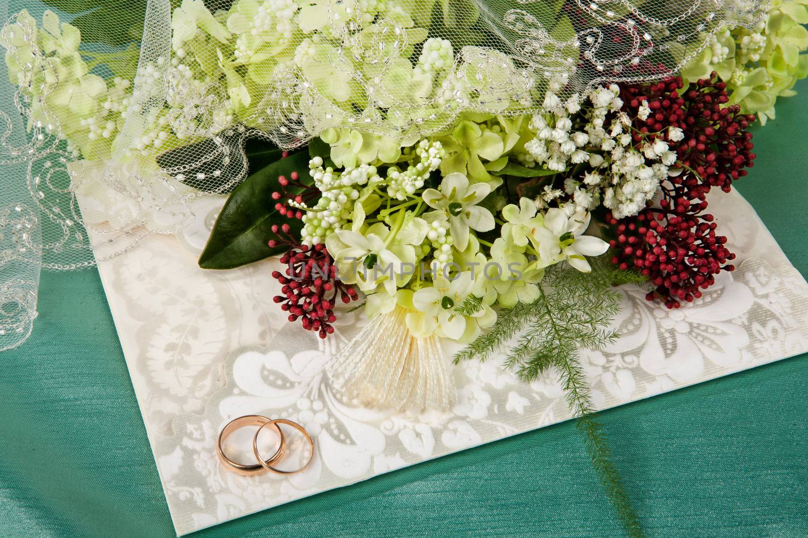 Still life with bouquet of flowers and accessories on a studio background
