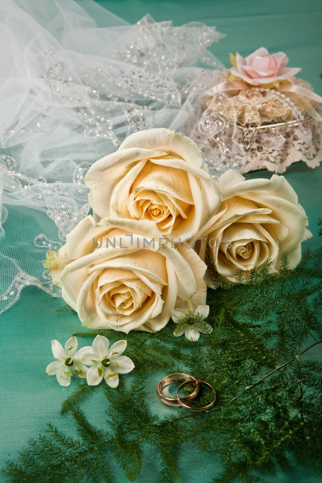 Still life with bouquet of flowers and accessories on a studio background