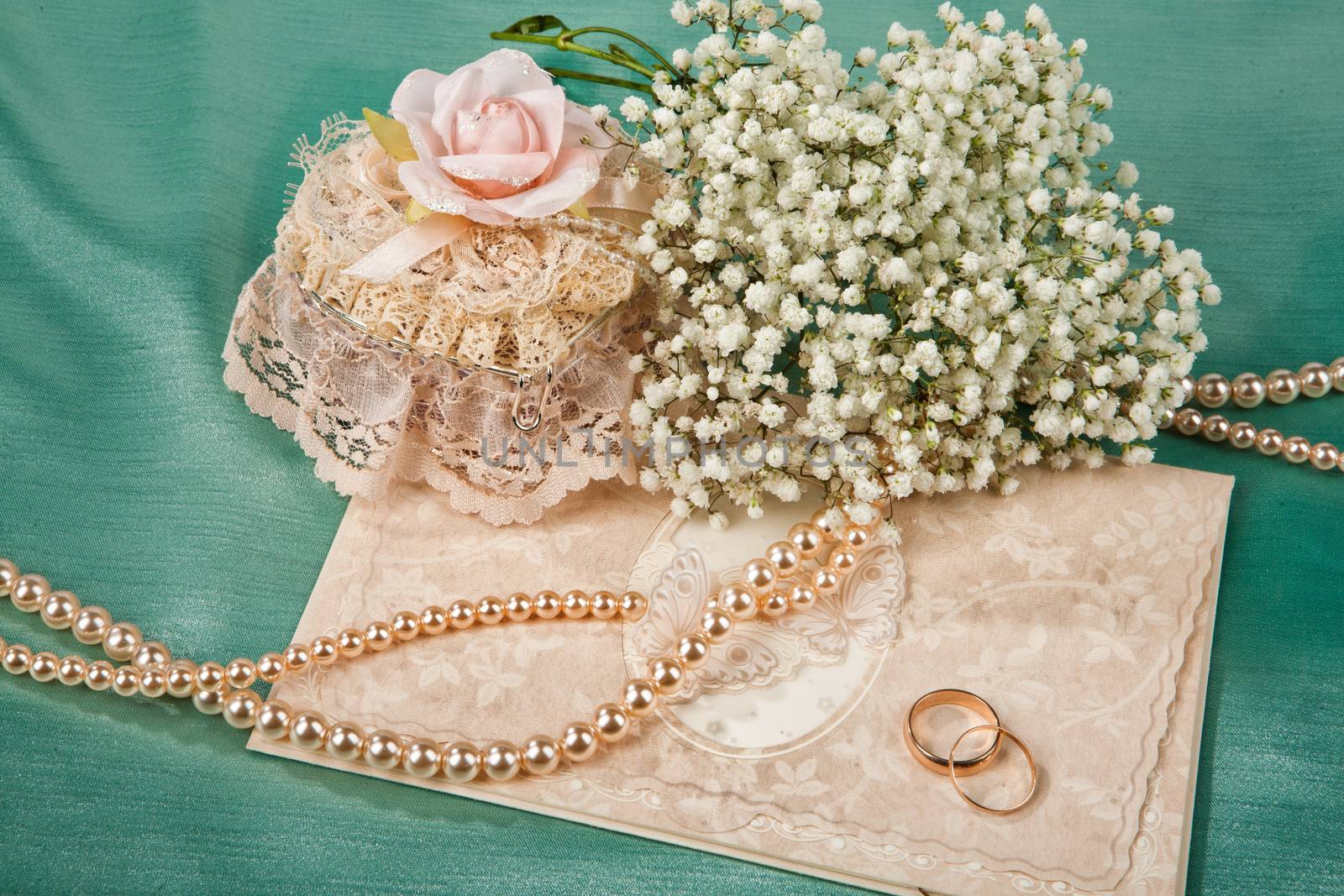 Still life with bouquet of flowers and accessories on a studio background