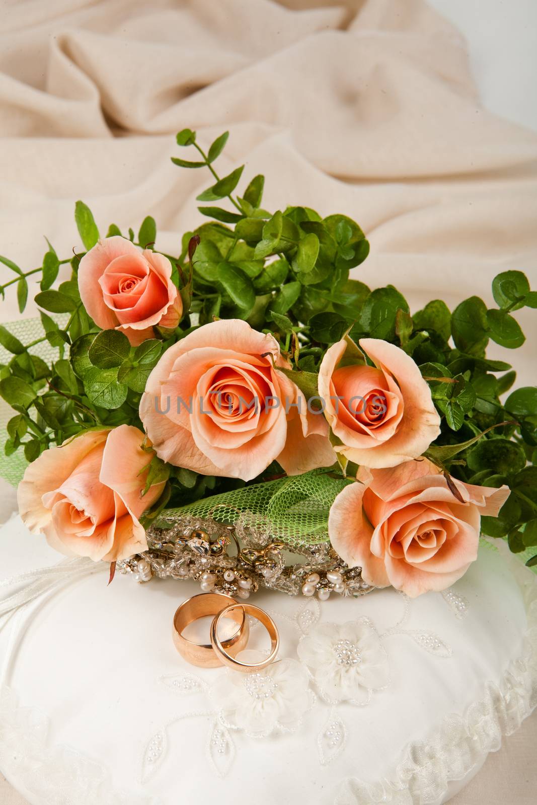 Still life with bouquet of flowers and accessories on a studio background