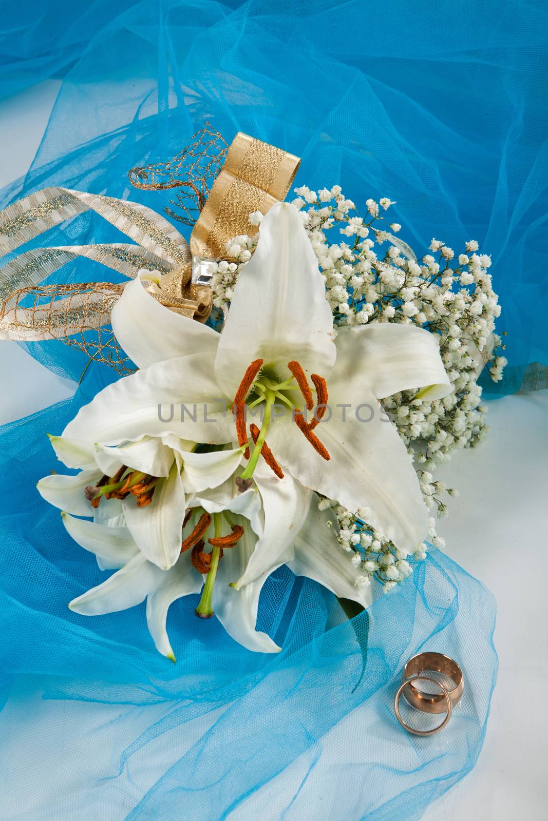 Still life with bouquet of flowers and accessories on a studio background