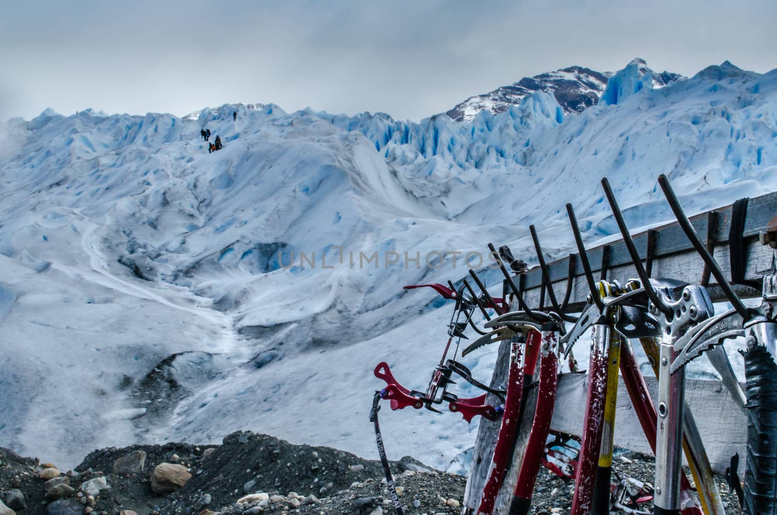 Some ice axes stand in front of the glacier waiting to be used by the tourists.