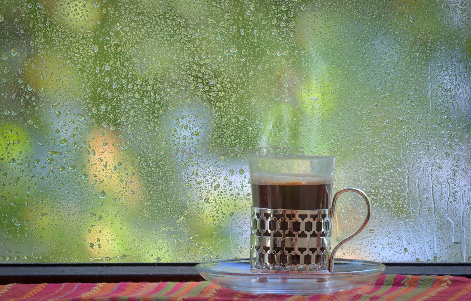 Fresh turkish coffee cup at rainy window