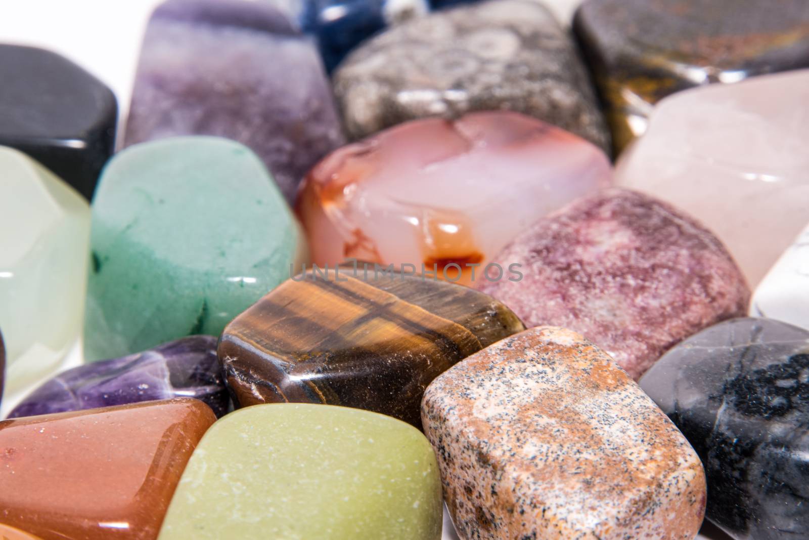 Collection of many kinds of polished gemstones originating from all continents